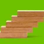 Decision Science Arts Fundraising — Stair blocks on a green background